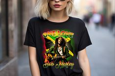 One Love Printed Bob Marley T-Shirt, Bob Marley Legend T-Shirt, Bob Marley Fan Sweatshirt, Custom Printed Shirts, One Love Unisex T-Shirt ✨Our Bob Marley "One Love" T-shirt is the ideal way to celebrate the legacy of the reggae legend. Highlighting the iconic "One Love" message, this custom-printed shirt can be personalized with your favorite colors, words, or images. Available in sizes Small to 3X, this unisex shirt is ideal for Bob Marley fans, couples, or anyone who appreciates immortal music and style. ✨Made using a commercial-grade DTG printer, each Bob Marley Legend shirt is pretreated and lint-rolled for a graceful, high-quality finish. Choose from colors like white, green, mint green, and tan to make this shirt personal yours. Features: ⦿ Customizable with colors, words, or images. Bob Marley T Shirts, Bob Marley Legend, Custom Printed Shirts, Love T Shirt, Bob Marley, Love Design, Unisex Shirt, Favorite Color, Custom Print