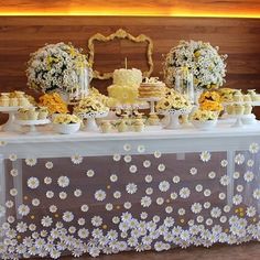 a table topped with cakes and cupcakes covered in flowers