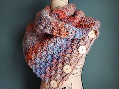 a close up of a mannequin wearing a knitted scarf