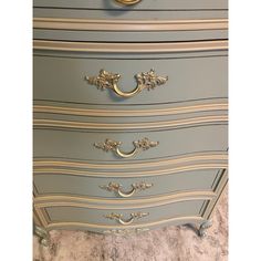 an antique dresser painted in blue and gold