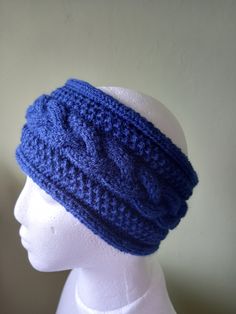 a white mannequin head with a blue knitted hat on top of it