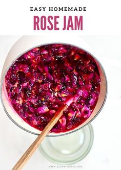 a bowl filled with red cabbage jam and a wooden spoon in the bowl next to it