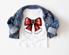 Christmas Santa's Belt Bow Girls Tee Shirt, Christmas Coquette Bow Toddler T-Shirt, Youth Christmas Bow Tee Shirt, Long or Short Sleeves 100% Polyester-Feels like super soft Cotton. Design will not fade.  Shirt will not shrink. Washing Instructions: Turn garment inside out. Machine wash COLD with mild detergent. NO bleach. Dry at a normal dryer setting on household machines. Do not dry clean. Instructions apply to the material only, please follow garment washing instructions as well.. Tee Shirt Long, Belt Bow, Santa Belts, Kids Birthday Shirts, Kids Tee Shirts, Christmas Coquette, Christmas Bow, Kids Graphic Tees, Coquette Bow