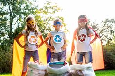 three children in costumes standing next to each other