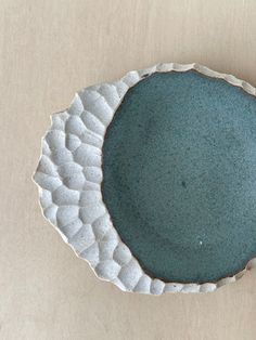 a blue bowl sitting on top of a wooden table