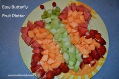 a plate full of cut up fruit on a table