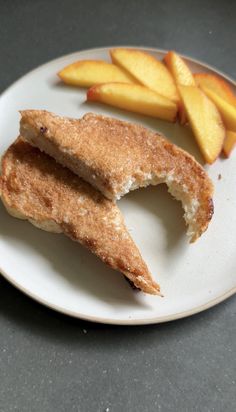 a white plate topped with two pieces of bread and apple slices