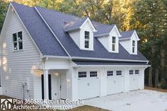 a two car garage with three dormers on the top and one story above it