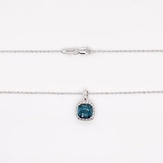 This cushion-shaped Midnight Blue Topaz has an incredibly vibrant color that is made even more beautiful by the diamond halo. The pendant pairs perfectly with the delicate baby rope chain that it is hanging on. This necklace would make the perfect gift for a loved one. The midnight blue topaz is also called London Blue Topaz. The details for this beautiful necklace are listed below:Metal Quality: 14K White Gold Pendant Style: London Blue Topaz, Diamond Halo Diamond Number: 20Diamond Shape: Round Halo Necklace, Blue Topaz Necklace, White Gold Pendant, Topaz Necklace, The Midnight, London Blue Topaz, Beautiful Necklace, London Blue, Diamond Halo