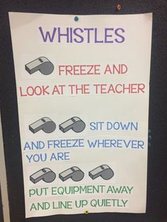 a sign that is posted on the side of a door saying, whistles freeze and look at the teacher