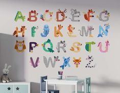 a child's room with colorful letters and animals on the wall