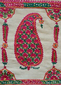 This is an antique Surat area embroidery from Gujarat, Indian in sumptuous green and pink dyed silk. The pink silk is cochineal and the green is from a combination of indigo and a yellow bearing plant. The design is in a beautiful boteh design filled with small flowers and framed by long serrated leaves forming a column between each boteh. It was probably made as a shawl with the boteh, or paisley, designs being on the end of the shawl or a hanging in and of itself with two pieces joined togethe Pink Raw Silk Dupatta With Intricate Embroidery, Transitional Green Raw Silk Embroidered Fabric, Transitional Pink Saree With Intricate Embroidery, Pink Saree With Intricate Embroidery For Transitional Season, Traditional Green Embroidered Raw Silk Fabric, Embroidered Pink Raw Silk Traditional Wear, Pink Embroidered Fabric With Traditional Drape, Pink Embroidered Fabric With Intricate Details For Festivals, Traditional Drape Pink Embroidered Fabric