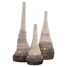 three large and small vases made out of woven material with lights on each side