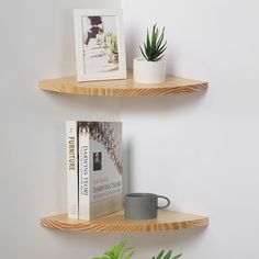 two wooden shelves with books and plants on them next to each other, one holding a coffee mug