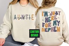 Elevate Auntie Style with Our Custom I'm Just Here Auntie Sweatshirt A Thoughtful Gift for Aunts Everywhere. The witty and charming statement, 'I'm Just Here,' not only adds a playful element but also captures the essence of the cool and laid-back auntie vibe. It's the perfect shirt for any occasion - whether you're spending quality time with your nephew, attending family gatherings, or simply embracing your role as the fun and stylish aunt. Surprise your favorite aunt with this thoughtful and p Graphic Print Tops For Birthday In Fall, Fall Birthday Crew Neck Tops, Casual Tops For Fall Birthday, Fall Birthday Tops With Name Print, Auntie Sweatshirt, Aunts Birthday, Aunt Birthday Gift, Aunt Shirt, Auntie Shirts