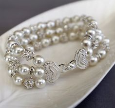 "This simple classic bridal bracelet features double strands Swarovski rhinestone balls and pearls with white gold filled crystal clasp.  Bracelet is about 7.5\" in length and 7/8\" in width Please read my Terms,Conditions and Shipping Information before you place the order: http://www.etsy.com/shop/LXdesigns/policy Any questions, please fell free to contact me." Luxury Traditional White Pearl Bracelet, Luxury White Crystal Bracelet For Wedding, Luxury White Pearl Embellished Bracelet, Luxury White Bracelet With Pearl Embellishments, Luxury White Bracelets With Pearl Embellishments, Luxury Exquisite Pearl Bracelet For Wedding, Luxury Pearl White Elegant Bracelets, Luxury Wedding Bracelets With Pearl Embellishments, Luxury Pearl White Beaded Bracelets For Formal Events