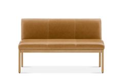 a tan leather bench with wooden legs