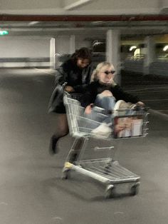 a man and woman pushing a shopping cart