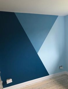 an empty room with blue and white paint on the walls