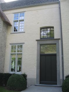 a white house with a black door and windows