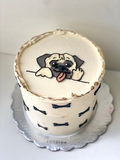 a cake decorated with a dog on it's face and tongue sticking out from the top