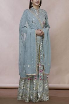 Grey floor-length anarkali with all over gota applique floral motifs. Comes with embellished dupatta.
Components:2
Gota, mirror embroidered
Neckline:Mandarin collar
Sleeve Length:Full
Fabric:Georgette
Color:Grey
Split neckline
Front slit
Contrast detail
Dupatta with lace border
Note: Pants worn by the model is for styling purpose only - Aza Fashions Aza Fashion Outfits, Lehenga Bollywood, Anarkali With Dupatta, Embroidered Anarkali, Formal Wear Dresses, Salwar Kamiz, Lehenga Collection, Muslimah Fashion Outfits, Dress Indian Style