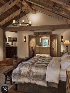 a large bed sitting under a wooden ceiling