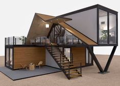 a small house with stairs leading up to the second floor and an open living area