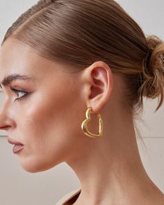 The Valentina Hoop Earrings feature a sleek heart shape design that's visible from all angles--front, side, and back. Designed for ease, they use a post hinge closure for convenient wear. Crafted in sterling silver and plated with 18K yellow gold or white gold, these earrings are both stylish and lightweight. Thanks to our exclusive Italian electroforming technique, they offer maximum comfort, even for long wear. Perfect as a gift for her, gift for mom, or best friend gift, these hoop earrings are an elegant, romantic statement piece. * Material: High Quality Solid 925 Sterling Silver * Finish: Sterling Silver ∙ 18K Gold (Yellow Gold, White Gold) * Closure: Hoop Stamp Closure * Approx. Measurement: Outer Length: 1.5 inches Outer Width: 1.4 inch * Silver weight: Approx. 0.23 oz Sold as a Pa Heart Shape Design, Mom Best Friend, Best Friend Birthday Gift, Friend Birthday Gift, Chunky Hoop Earrings, Gold Hoops, Jewelry Earrings Hoops, Elegant Earrings, Elegant Jewelry