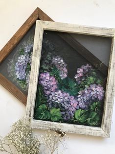 a painting of purple flowers in a wooden frame