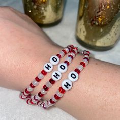 "Festive Christmas bracelet set. Made with red and white glass beads and white plastic alphabet letters that spell out \"HO HO HO\". Set includes 3 bracelets, with each bracelet bearing one word. The perfect accessory for your favorite Christmas sweater, or a cute stocking stuffer!" Kandi Beads, Heishi Bracelets, Cute Stocking, Seed Bead Bracelet Patterns, Preppy Bracelets, Bracelet Inspo, Christmas Message, Message Bracelet, Cute Stockings