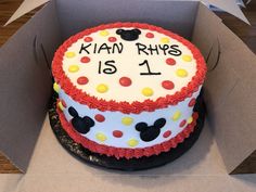 a mickey mouse cake in a box on a table