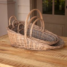 two wicker baskets sitting on top of a wooden table