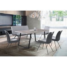 a dining room table with chairs and a television in the backgroung area