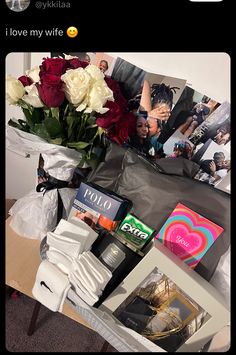 a bouquet of roses, socks and other items are sitting on a table in front of a photo