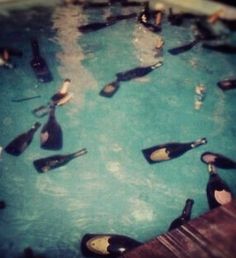 there are many bottles in the water and one is filled with people's feet