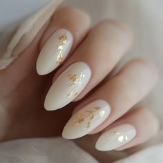 Embrace simplicity and elegance with milky white nails accented with delicate gold leaf details. This timeless design is perfect for minimalistic yet luxurious looks.    **Steps to Create the Look:**   1. Apply a milky white base coat to all nails.   2. Gently place small pieces of gold leaf on select areas of the nails using tweezers.   3. Press the gold leaf lightly to adhere it to the nail.   4. Seal the design with a clear glossy topcoat for a smooth and polished finish. Milky White Nails With Gold, Nails With Gold Leaf, Milky White Nails, White Nails With Gold, Nails With Gold, Elegant Nail, Elegant Nail Art, Accent Nails, Milky White