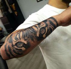 a man with a tiger tattoo on his arm and shoulder, in front of an instagram page