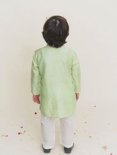 Boys full sleeves elephant katha green viscose silk kurta with white cotton pajamas. Color: Green and White Fabric: Viscose Silk and Cotton Note: The product will be delivered within 2-4 weeks of order placed Wash Care - Dry clean only No returns and Exchange. Measure before ordering to avoid any returns. Measurements: SIZE CHART FOR GIRLS Age CHEST ROUND WAIST ROUND KURTA LENGTH SLEEVE LENGTH BOTTOM LENGTH CHEST ROUND (ANGRAKHA) DRESS LENGTH (angrakha) LEHENGA BLOUSE LENGTH LEHENGA CHEST LEHENG Pista Green Long Sleeve Sets For Diwali, Pista Green Long Sleeve Cotton Sets, Green Cotton Sherwani With Straight Kurta, Green Cotton Long Sleeve Sherwani, Green Long Sleeve Kurta For Eid, Green Long Sleeve Cotton Traditional Wear, Green Long Sleeve Cotton Kurta, Pista Green Long Sleeve Cotton Kurta, Pista Green Cotton Traditional Long Sleeve Wear