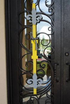 an iron door with yellow and white tape on the front entrance to a home in florida