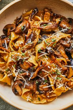 pasta with mushrooms and parmesan cheese in a bowl