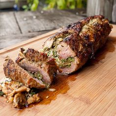 a large piece of meat sitting on top of a wooden cutting board