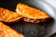 two fried food items in a frying pan