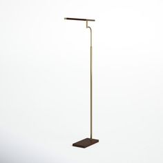 the floor lamp is made from brass and has a wooden base with a metal pole