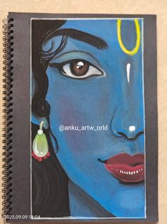 a spiral notebook with an image of a woman's face and ear rings on it