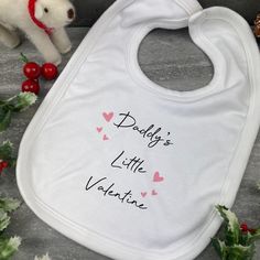 This cute baby bib is the perfect gift for your baby on valentines day! Please select options for mummy or daddy from the drop down list. Each bib has a Velcro fastening and is super soft! The print is dye sublimated into the bib meaning that there will be no peeling off. Cute Pink Bib For Gift, Cute Pink Bib As A Gift, Cute Pink Bib As Gift, Personalized White Bib For Birthday, Cute Personalized Birthday Bib, Personalized White Birthday Bib, Cute White Bib For First Birthday, Customizable White Birthday Bib, Reindeer Dust