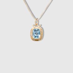 3.65ct Faceted Checkerboard Light Blue Topaz Charm Pendant Necklace with Diamonds, 24kt Gold and Silver by Prehistoric Works of Istanbul, Turkey. Light Blue Topaz - 3.65cts, Diamonds - 0.08cts. This stunning topaz is framed in 24kt gold with 8 diamonds. Looks beautiful alone or paired with other charms.  Sure to make a subtle, striking statement.  Measures 12.5mm x 17mm. 24kt Gold - 1.57 g Sterling Silver - 0.87 g Diamonds - 0.08 ct Blue Topaz - 3.65 ct Luxury Yellow Gold Jewelry With Blue Topaz, Luxury Yellow Gold Blue Topaz Jewelry, Luxury Blue Topaz Yellow Gold Jewelry, Luxury Topaz Necklace With Diamond Accents, Formal Yellow Gold Necklace With Accent Stones, Luxury Blue Topaz Birthstone Jewelry, Luxury Diamond Necklaces With Accent Stones, Yellow Gold Blue Topaz Pendant, Formal Blue Topaz Gold Jewelry