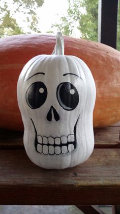 a pumpkin with a skull painted on it