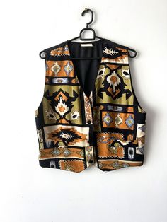 "Vintage Women's summer vest Patterned viscose Vest Button Up Waistcoat Hippie Festival Vest Size Large Retro vest 90s lady vest Label size: 40 Estimated size: L Measurements (lying flat): Length: 20.5\"/ 51 cm Pit to pit: 21\"/ 53.3 cm Waist: 19\"/ 48 cm Please check measurements to insure a proper fit. Remember to allow yourself some extra room for movement. You can compare these with something from your closet that fits you well. This vest will come to you freshly laundered and ready to wear. Please convo me if you need additional measurements. Condition: great Vintage Condition Label: memories SHIPPING * I ship worldwide via Priority mail (Latvijas Pasts) from Latvia (EU). * I ship from Europe, so please allow 2 to 4 weeks for the package to arrive if you live overseas. * Europe 5 - 10 Retro Fitted Vest For Summer, Retro Fitted Summer Vest, Bohemian Sleeveless Vest With Buttons, Vintage Vest For Festivals, Multicolor Retro Summer Vest, Retro Multicolor Summer Vest, Hippie Sleeveless Cotton Vest, Retro V-neck Spring Vest, Vintage Festival Vest