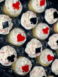 cupcakes with white frosting and red hearts are arranged on top of each other